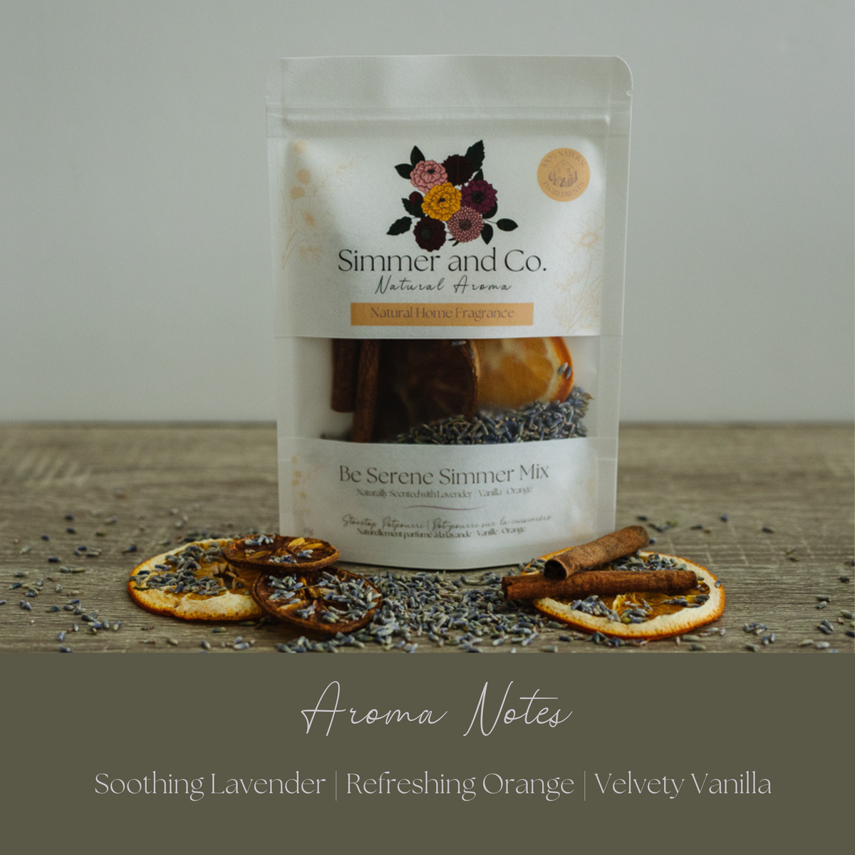 A stand-up pouch of Simmer and Co. Natural Aroma 'Be Serene Summer Mix' fragrance ingredients, displayed on a rustic wooden surface with dried orange slices, lavender buds, and cinnamon sticks.