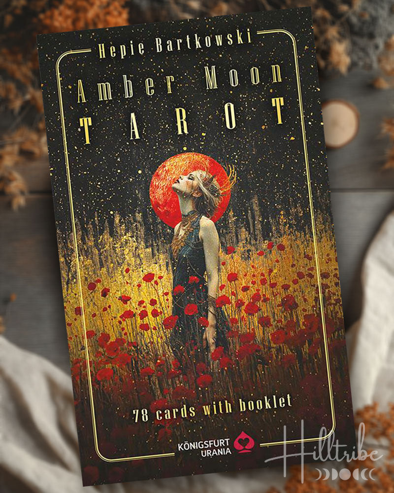 Amber Moon Tarot card set packaging with a woman in a field of flowers and red moon.
