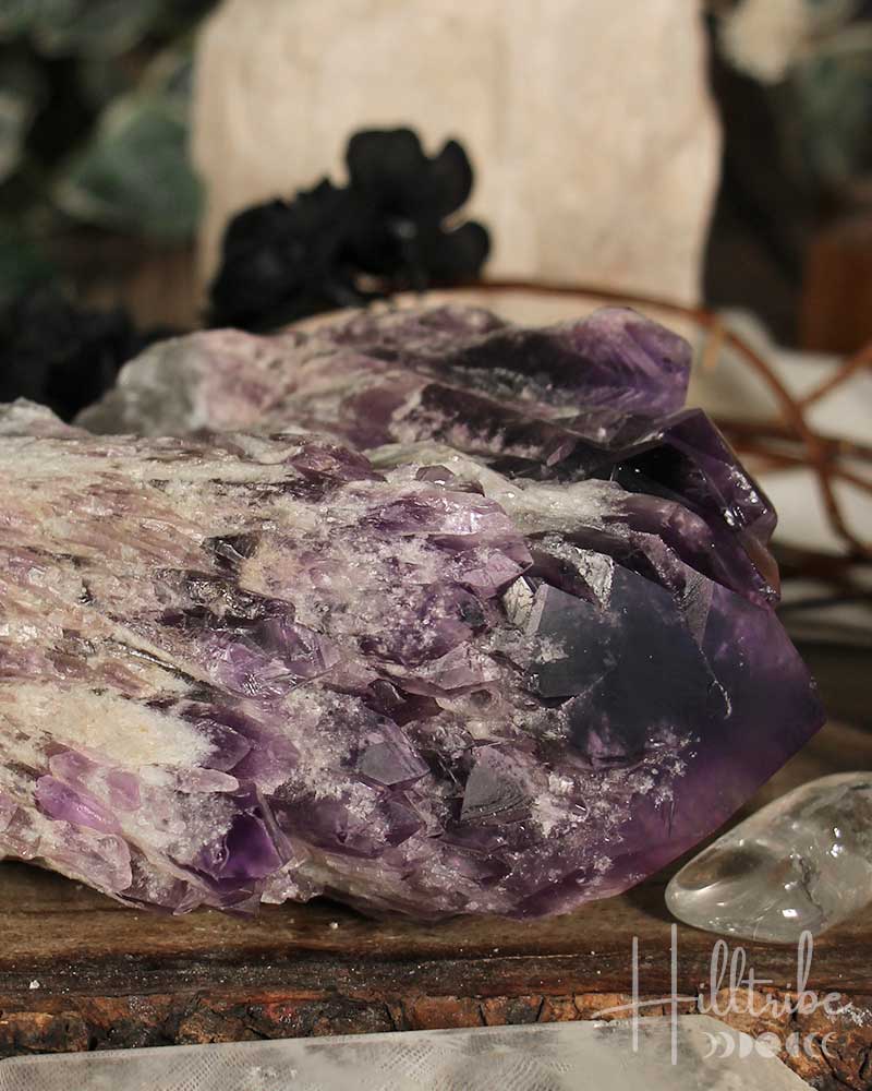 Amethyst crystal on a wooden surface with blurred background