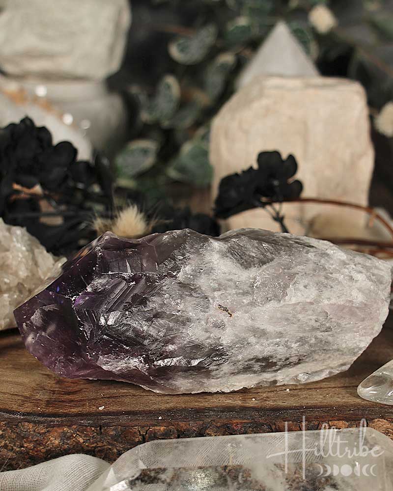 Amethyst crystal on a wooden surface with blurred background