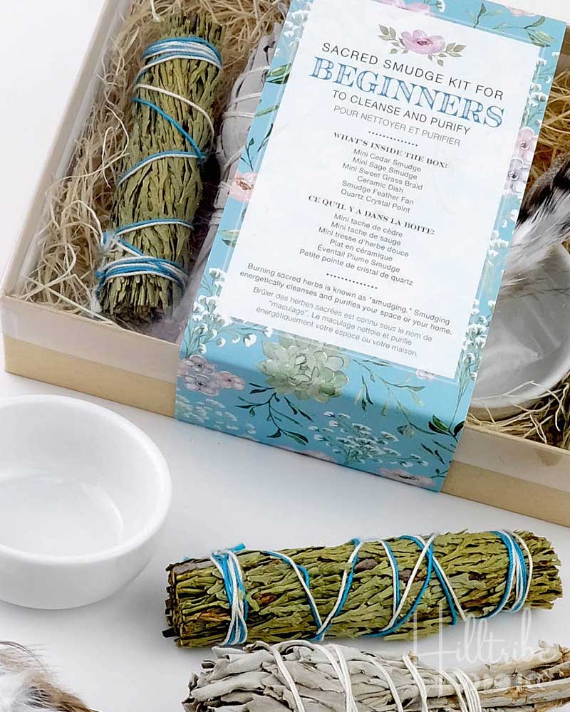 Sacred smudge kit for beginners with sage and white sage sticks on a white surface.
