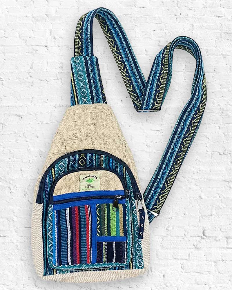 Small bag with a colorful strap on a white brick background