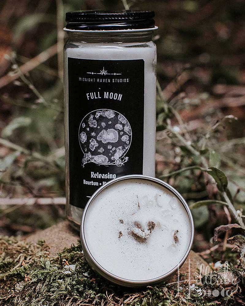 Candle with 'Full Moon' label on a natural background