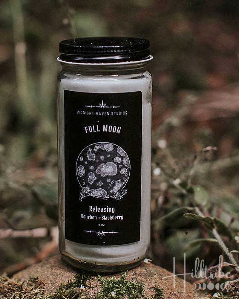 Candle jar with black label on a natural background