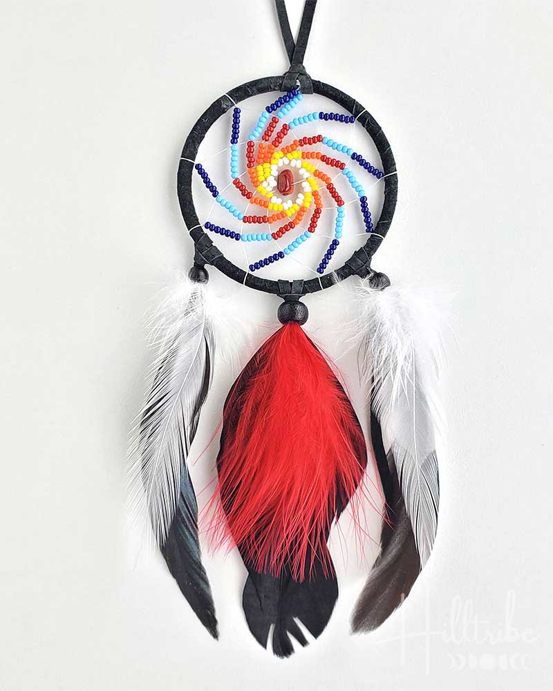 Colorful dreamcatcher with feathers on a white background