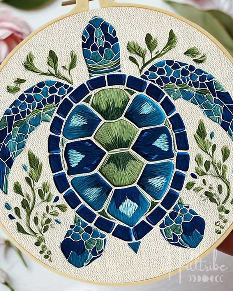 Mosaic turtle art piece with blue and green colors on a white background