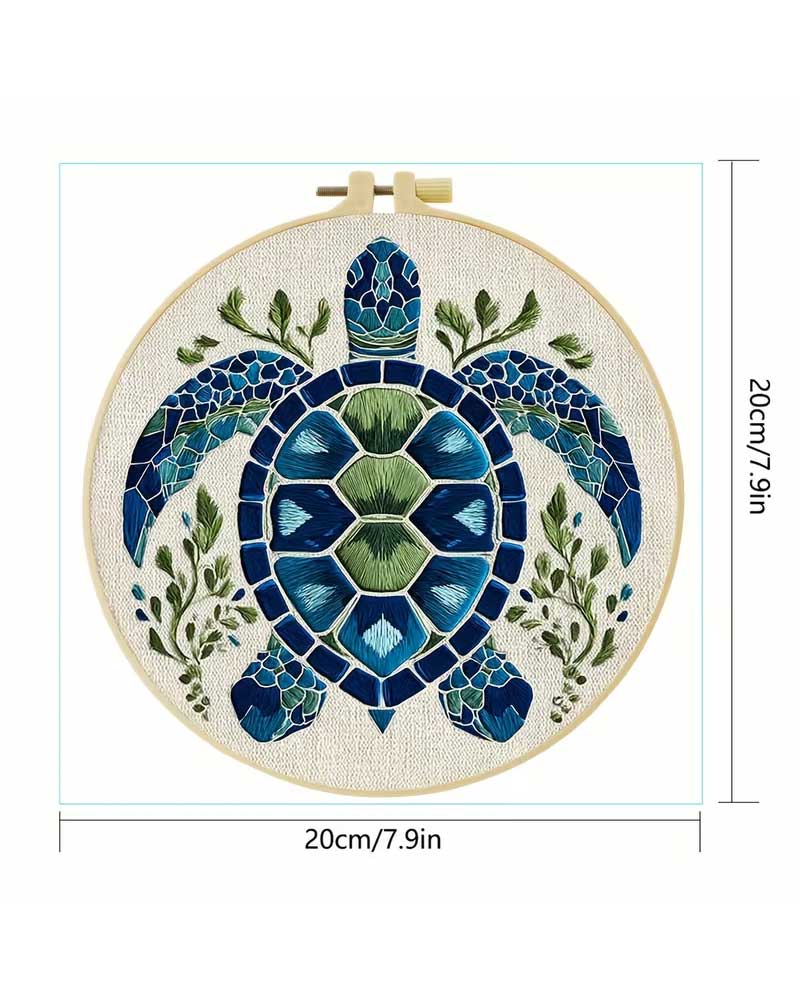 Embroidery hoop with a turtle design and measurements on a white background