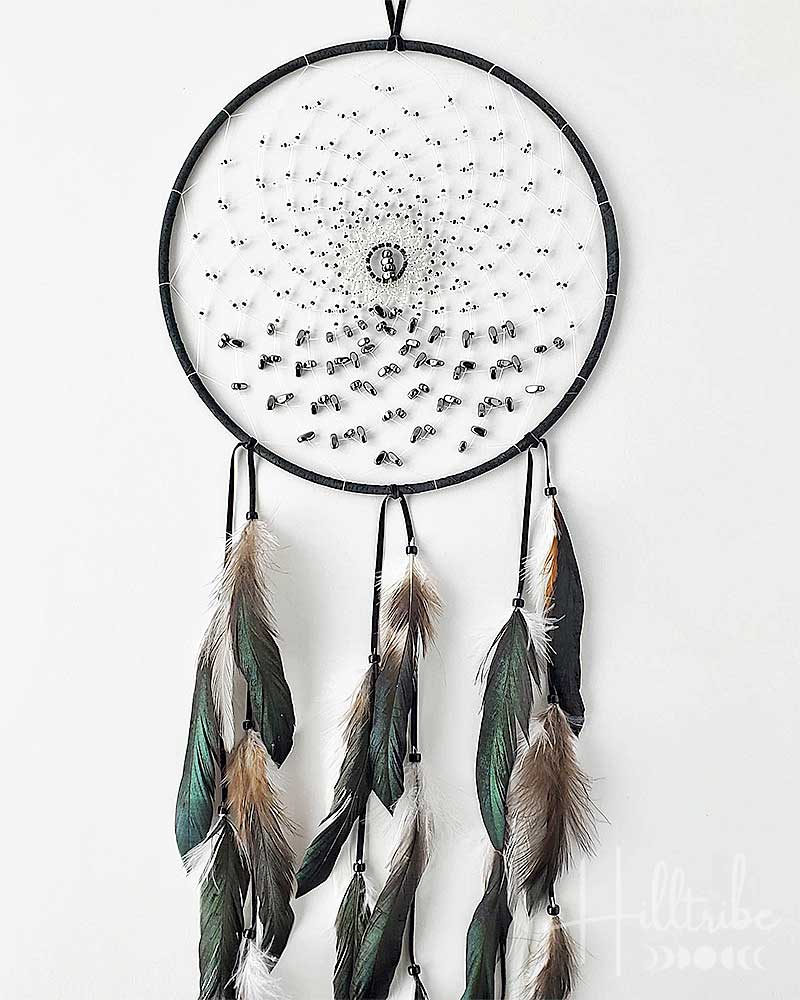 Dreamcatcher with feathers on a white background