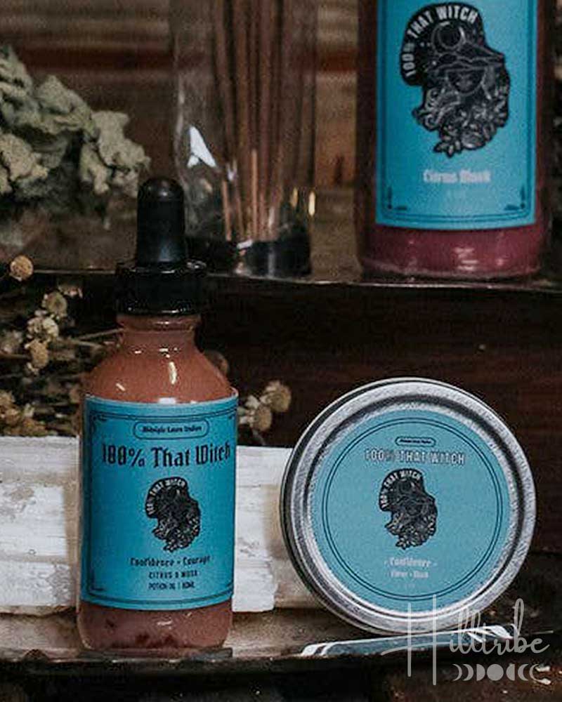 Collection of natural products, including candles, oils, and a crystal, on a wooden surface with a rustic background.
