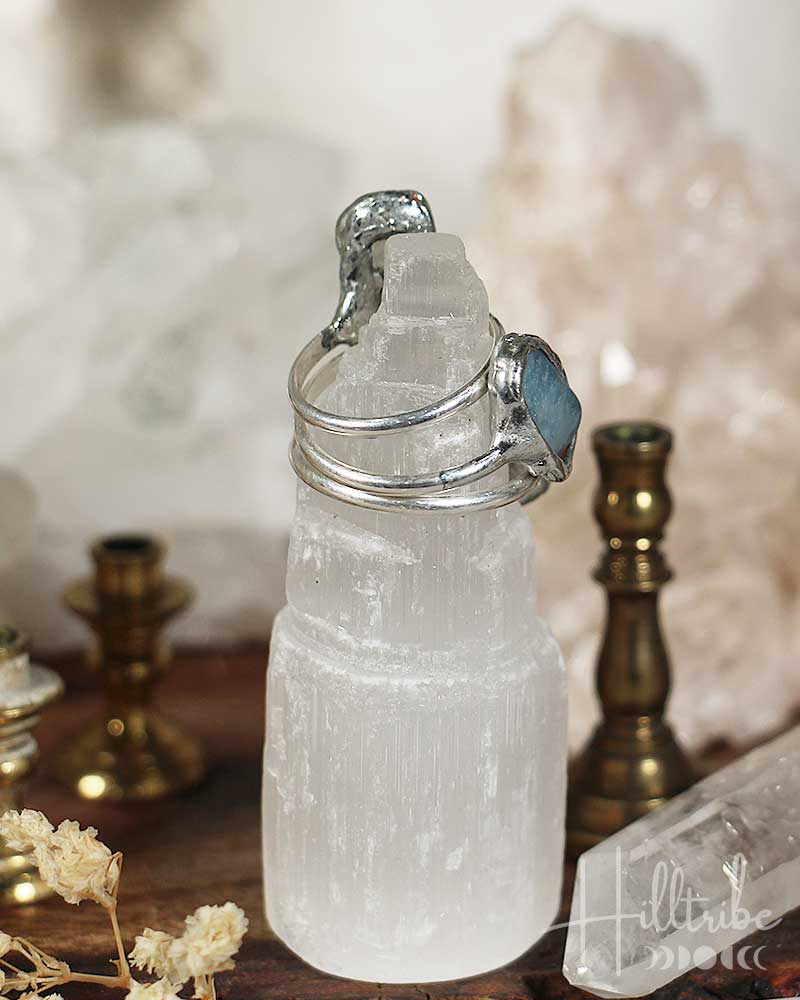 Crystal mug with silver handle on a wooden surface with blurred background