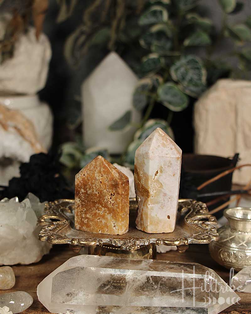 Two Rose Amethyst and Jasper Mini crystal towers on a decorative stand with a blurred background