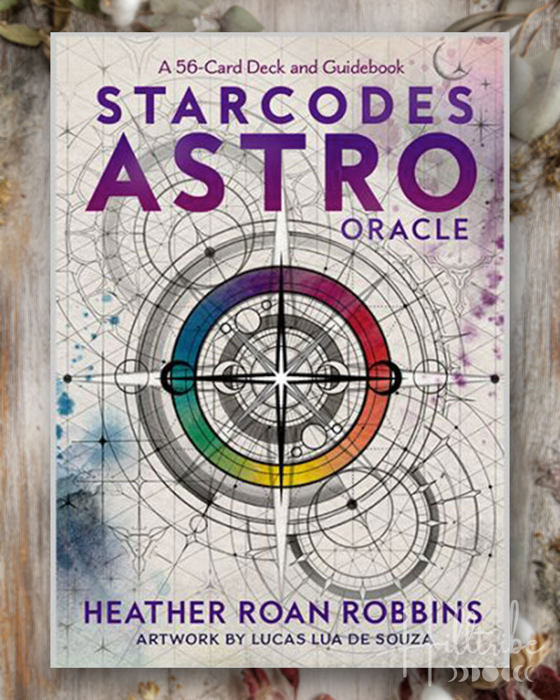 Starcodes Astro Oracle deck cover with astrological design and text on a wooden surface.