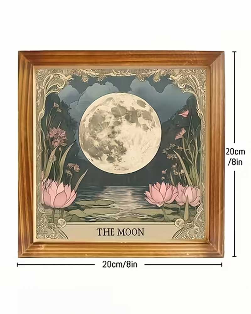 Framed wall art showing a large moon over pink lotus flowers and water, with decorative ornate corners and the text 'THE MOON' at the bottom. The image includes dimension labels indicating 30cm height and 20cm width, under the heading 'PRODUCT DETAILS' on a white background.