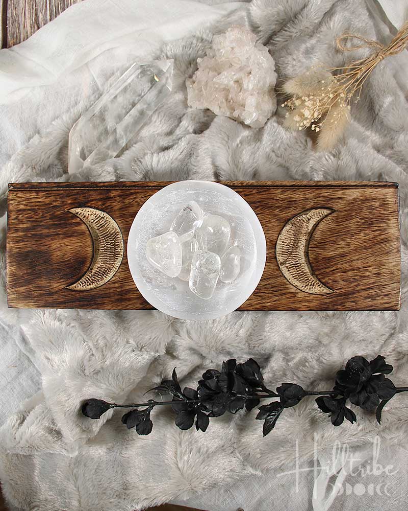 Triple Moon Tarot Card Holder with moon designs and a crystal on a textured surface.