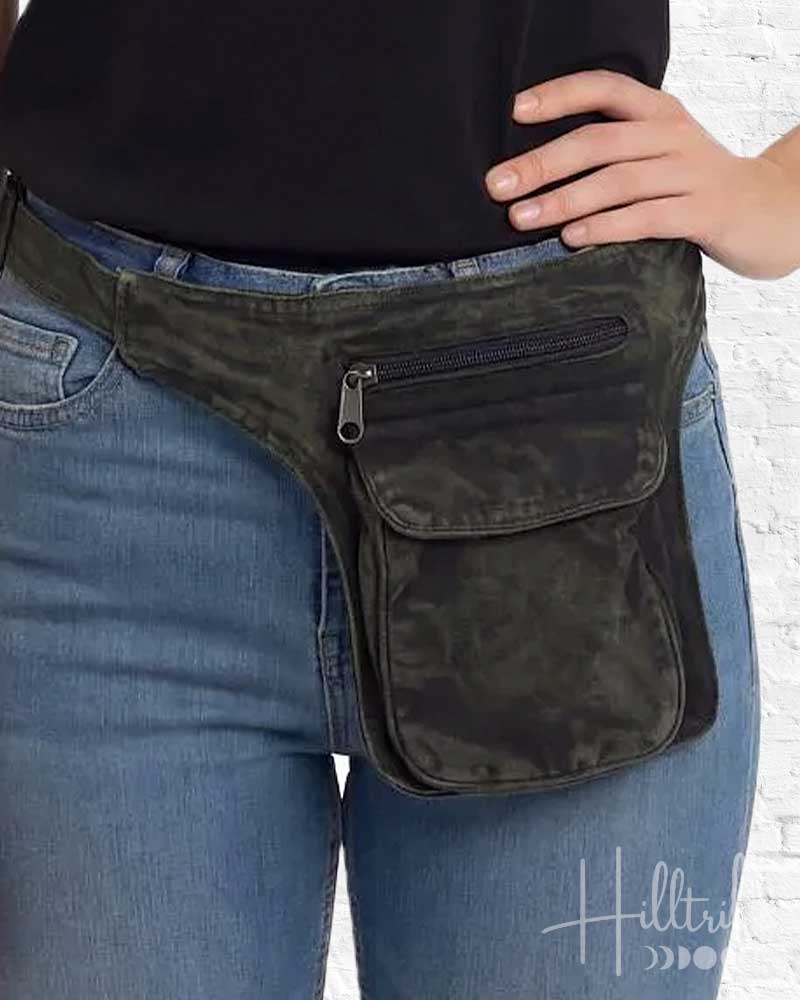 Person wearing a black waist bag with a visible brand logo on jeans.