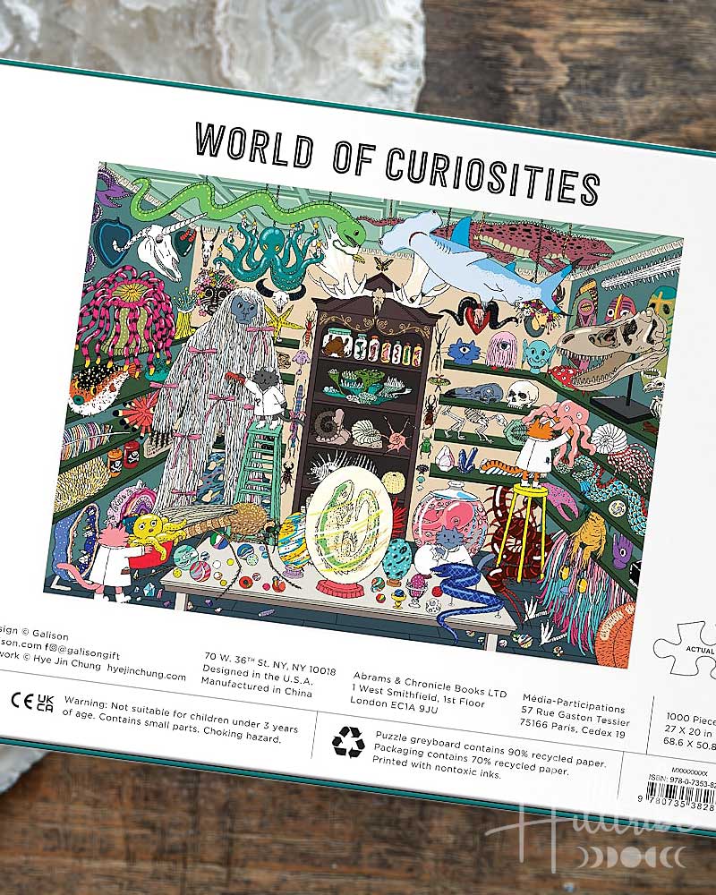 Puzzle box with colorful illustration and 'World of Curiosities' text on a white background