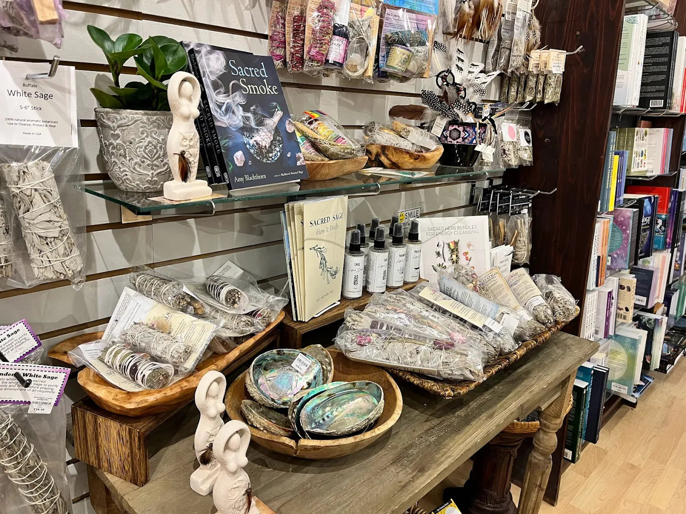Display of wiccan supplies including books, incense, and statues in a store.