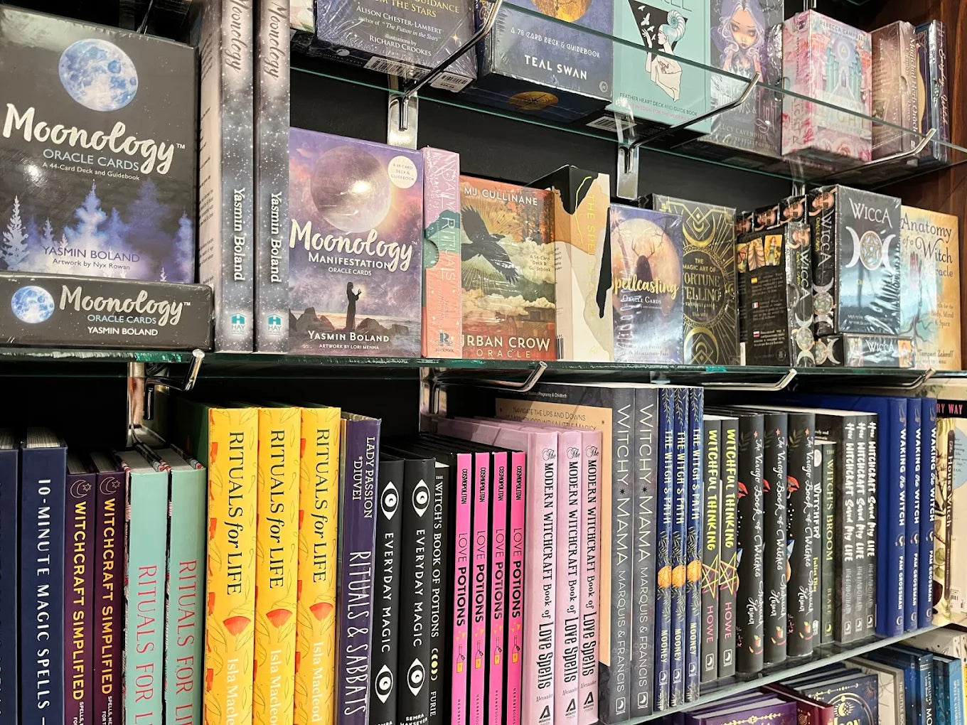 Shelves filled with books on various topics including 'Moonology' and 'Witchcraft', with a focus on spirituality and magic.