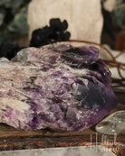 Amethyst crystal on a wooden surface with blurred background