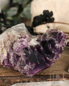 Amethyst crystal on a wooden surface with blurred background
