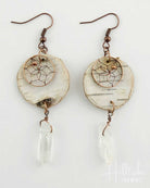 Pair of earrings with shell and dreamcatcher design on a white background