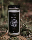 Candle jar with black label on a natural background