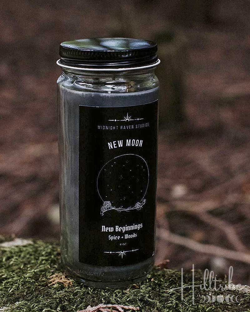 Candle jar labeled 'New Moon' with a black label on a natural background