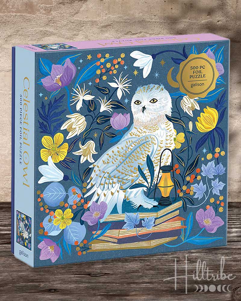 A 500-piece foil puzzle box by Galton titled 'Celestial Owl'. The box features a detailed illustration of an owl perched on books surrounded by flowers and a lantern against a dark blue starry background.
