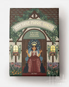 Cottage Magic Tarot box with illustration of a woman in a chair and cats, surrounded by foliage and flowers.