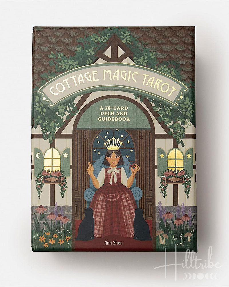 Cottage Magic Tarot box with illustration of a woman in a chair and cats, surrounded by foliage and flowers.