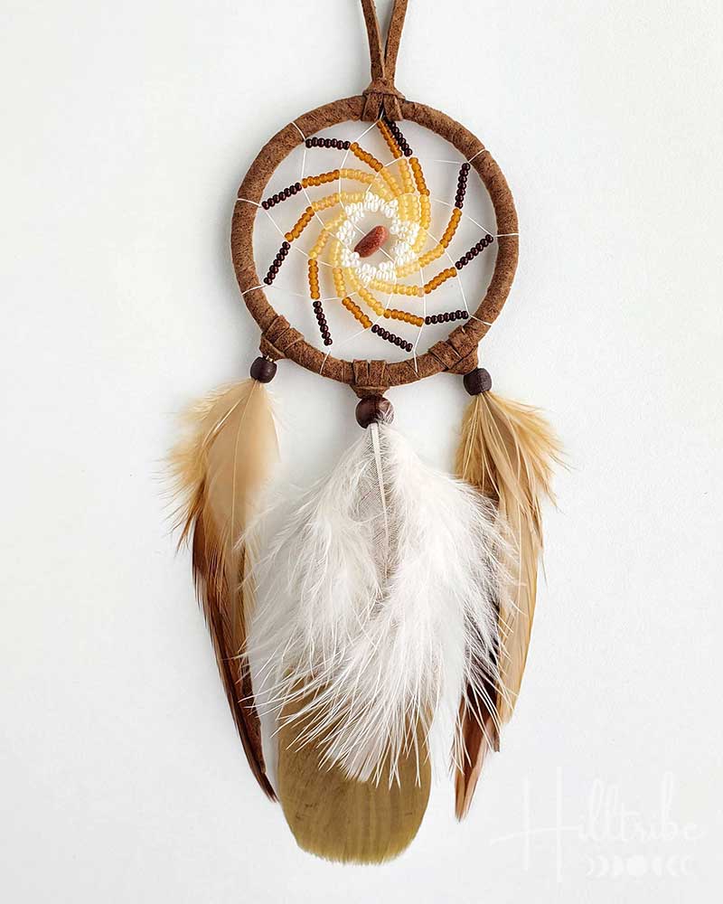 Dreamcatcher with feathers on a white background