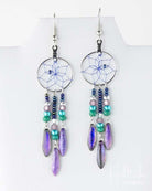 Pair of dreamcatcher earrings with colorful beads on a white background
