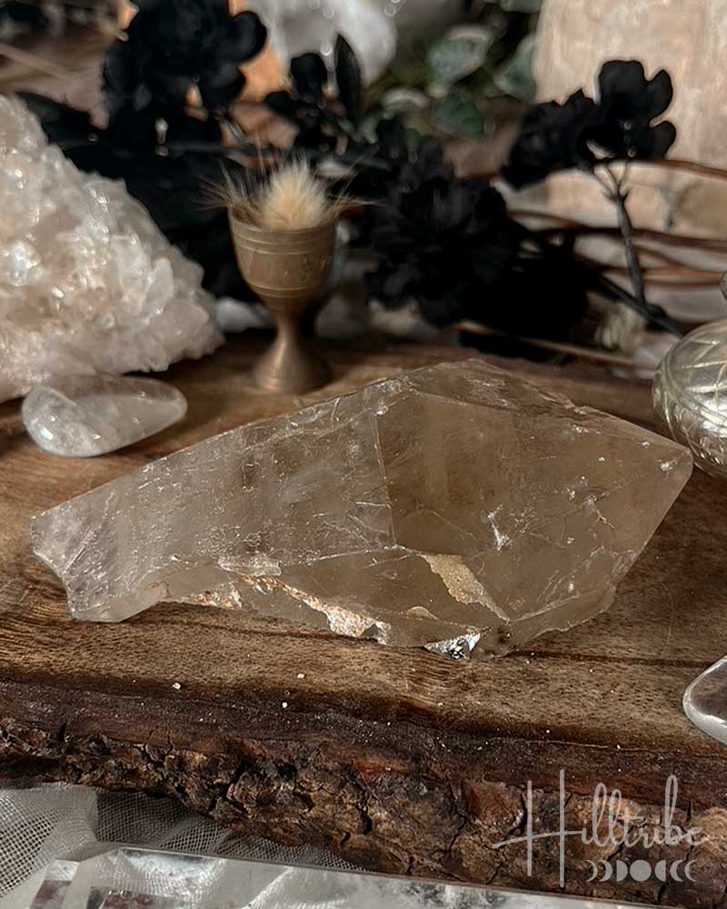 Smoky Citrine crystal on a wooden surface with blurred background