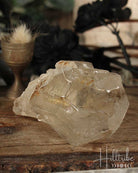 Natural Smoky Citrine crystal on a wooden surface with a blurred natural background