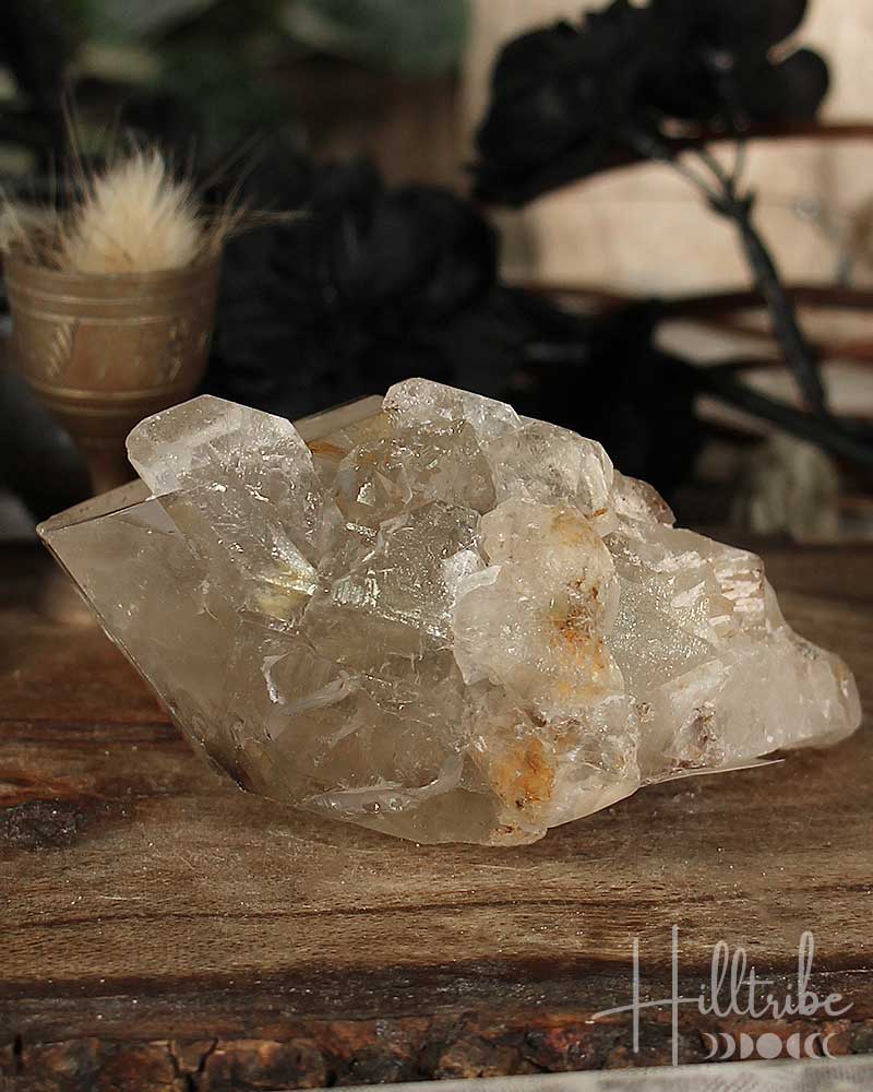 Natural Smoky Citrine crystal on a wooden surface with a blurred natural background