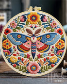 Embroidery hoop with a colorful butterfly and floral design.