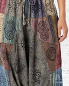 Multicolored patchwork dress with embroidered designs on a white background