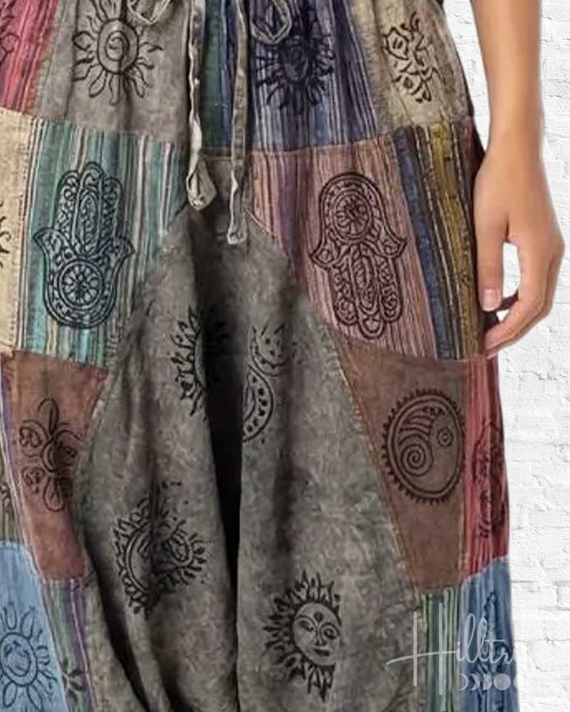 Multicolored patchwork dress with embroidered designs on a white background