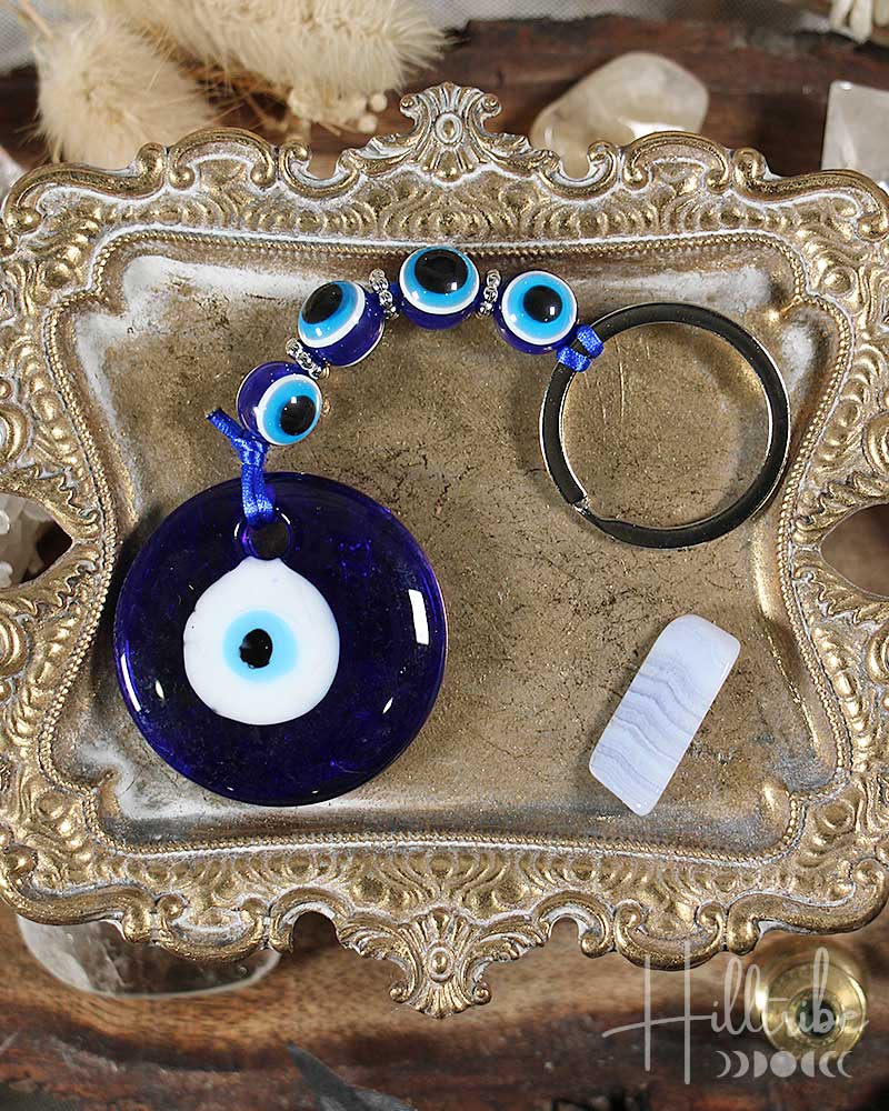 Nazar keychain with blue evil eye design on a decorative metal tray