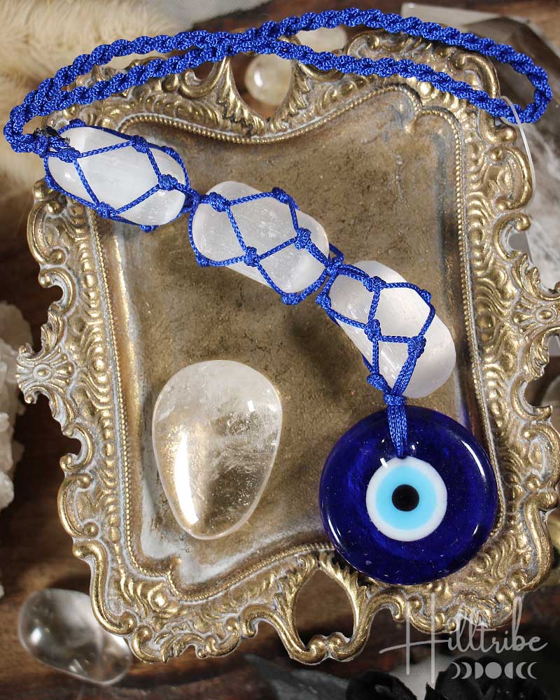 Evil Eye and Selenite Talisman on a decorative metal tray