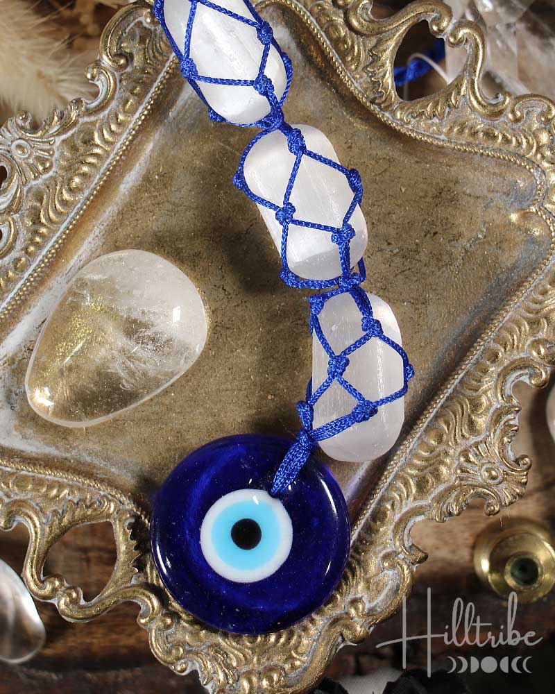 Evil Eye and Selenite Talisman on a decorative metal tray
