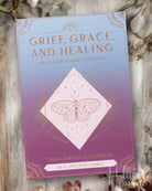Grief, Grace, and Healing Oracle Deck and Guidebook with a butterfly illustration on a wooden surface.