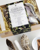 Sacred smudge kit with feathers and incense on a white surface