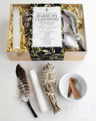 Harmony Cleansing smudge kit with incense, feather, and other items on a white background