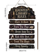 A 2D flat wooden hanging sign with Halloween-themed text and illustrations, shown with dimension lines and measurements on a white background. The sign reads 'Haunted Library Rules' and includes additional phrases: 'Open A Book,' 'Turn The Page,' 'Drink Some Tea,' 'Read After Dark,' 'Trust The Magic,' and 'Stay Spooky.