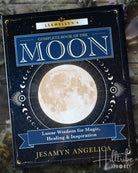 Book titled 'Llewellyn's Complete Book of the Moon' by Jesamyn Angelica on a wooden surface.