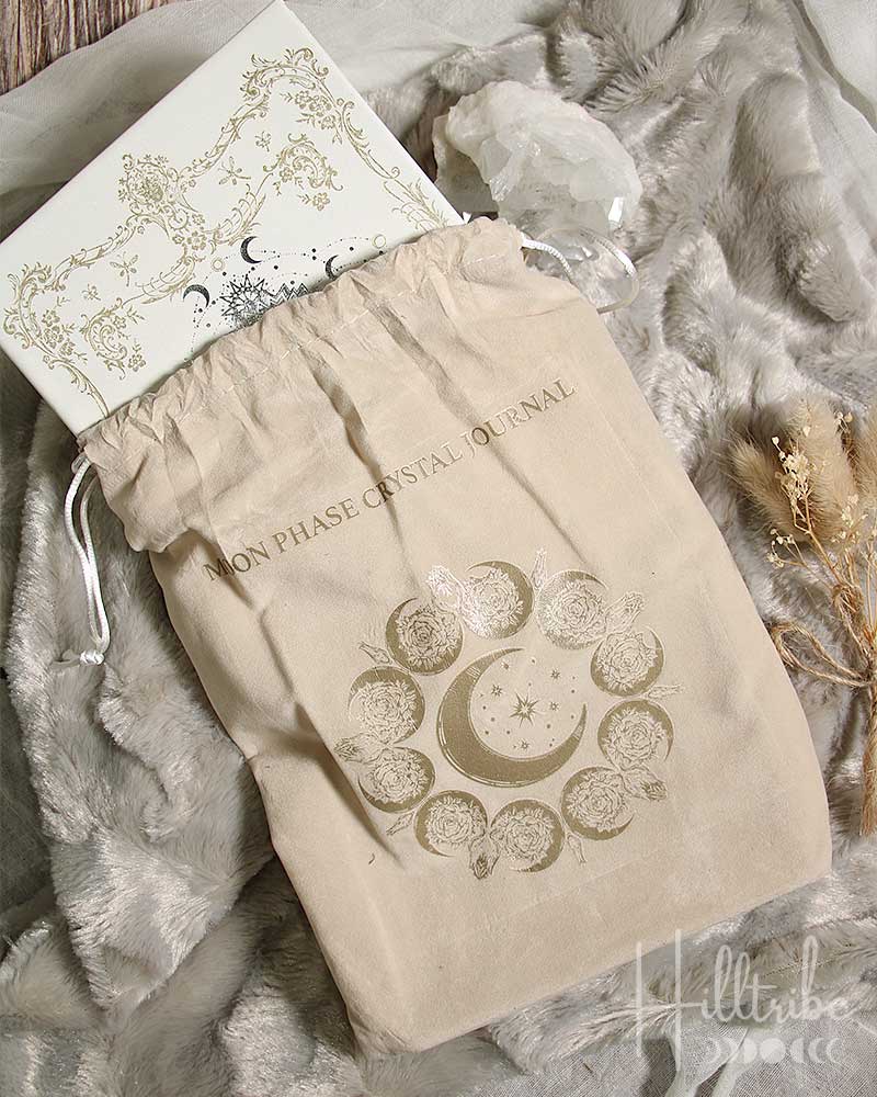 Beige drawstring bag with celestial design on a textured surface