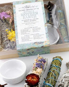 Sacred smudge kit for Mother Earth with incense sticks, flowers, and a bowl on a white surface.