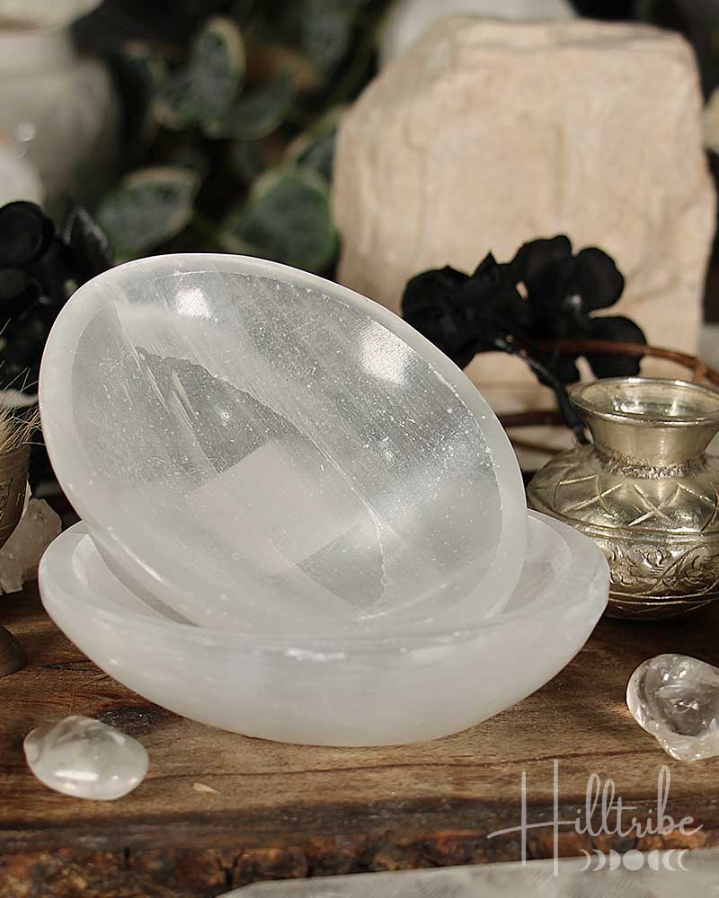 Selenite Crystal bowl on a wooden surface with blurred background