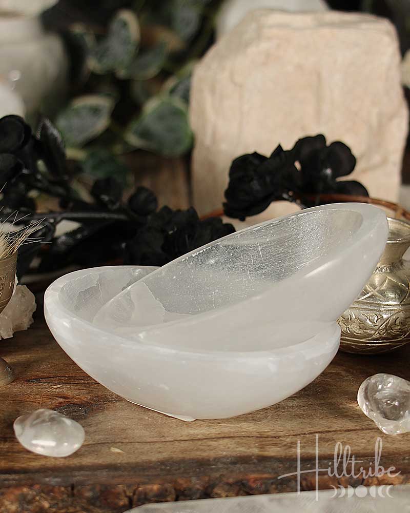 Selenite Crystal bowl on a wooden surface with blurred background